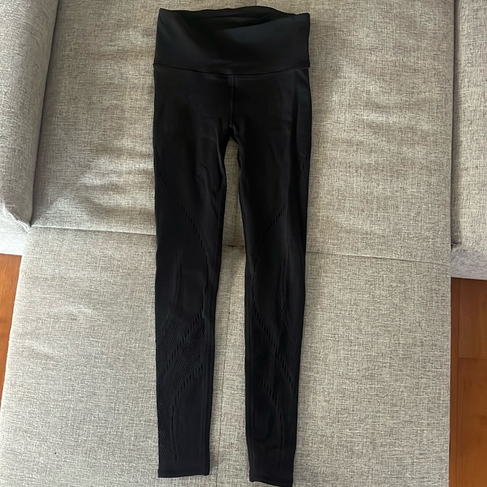 Lululemon black leggings with cute small cutouts. Size 6, worn once, EUC